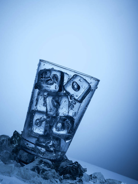 plastic bottle and a glass with ice - Photo, Image