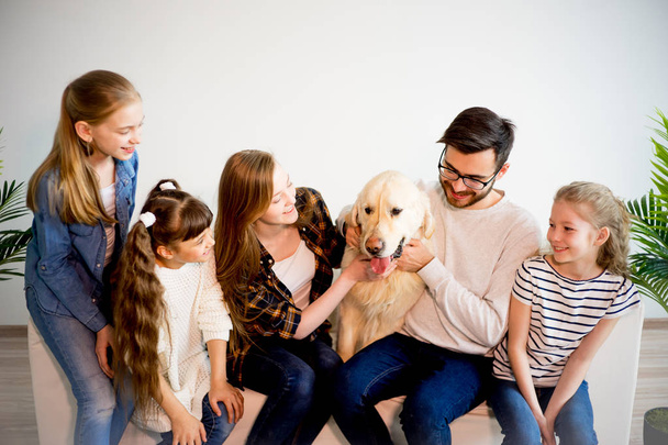 Family playing with a dog - Foto, imagen