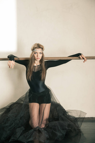 Emotions of a ballet dancer at ballet barre on her knees - Zdjęcie, obraz