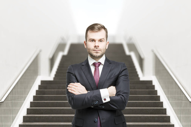 Confident businessman on staircase front - Photo, Image