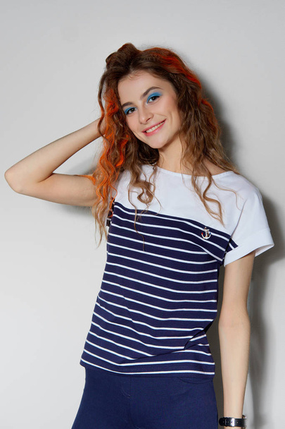 Portrait of happy girl in t-shirt touching strands of hair paint - Valokuva, kuva