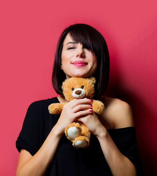woman holding teddy bear - 写真・画像