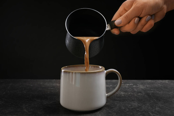 hand pouring coffee into cup - Photo, Image