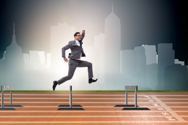 Businessman jumping over barriers in business concept - Foto, Imagem