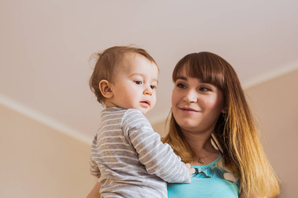 Happy mother with adorable baby boy indoors - Valokuva, kuva