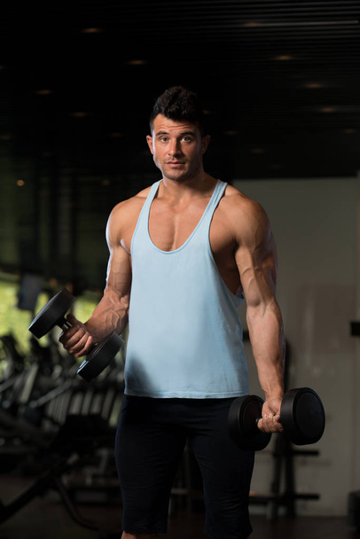 Muscular Man Exercising Biceps With Dumbbell - Fotoğraf, Görsel