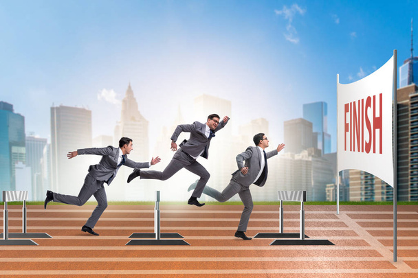 Businessman jumping over barriers in business concept - Photo, Image