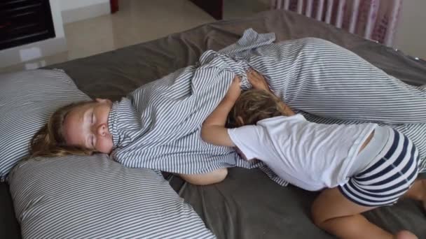  little Son wakes up mom at home - Filmati, video