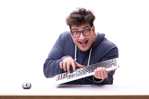Смешной ботаник, работающий на компьютере, изолированный на белом - Фото, изображение