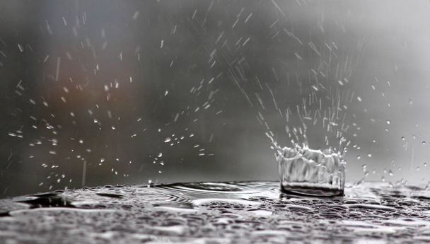 raindrops falling on a table surface - Photo, Image
