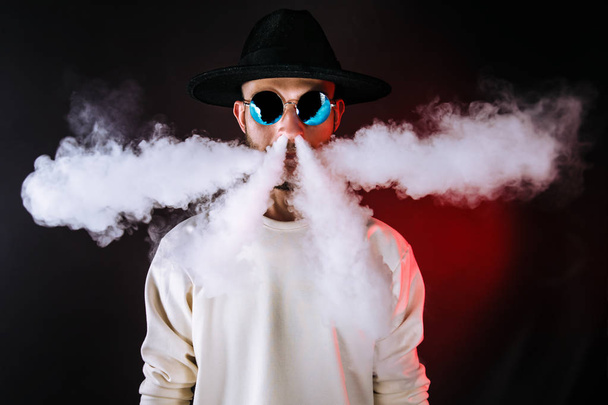 Stylish man puffing vapor - Фото, изображение