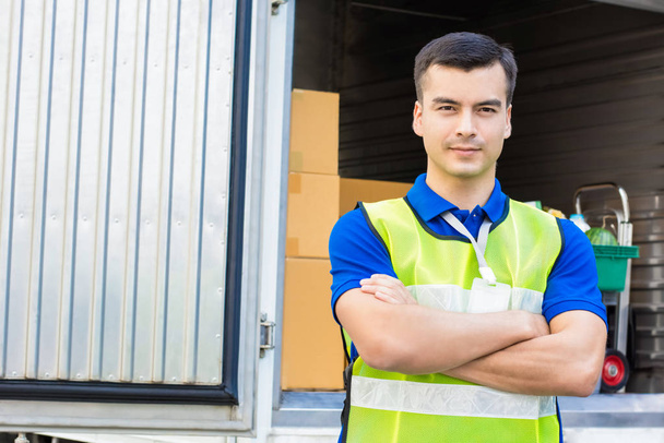 Delivery man standing with arm crossed - Photo, Image