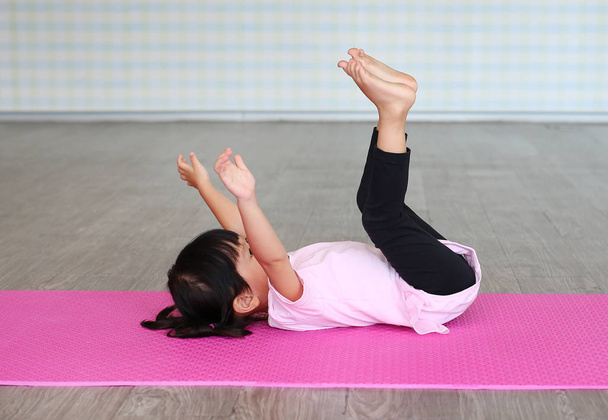 Cute toddler girl practicing yoga and doing exercise - Photo, Image