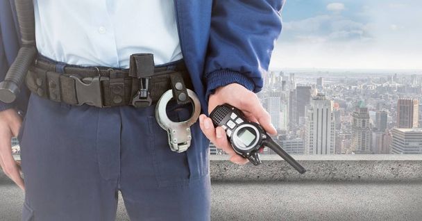 Security guard lower body with walkie talkie against skyline - Fotó, kép