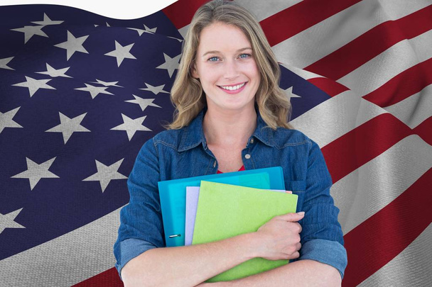 students is holding notebooks against American flag background - Foto, Imagen