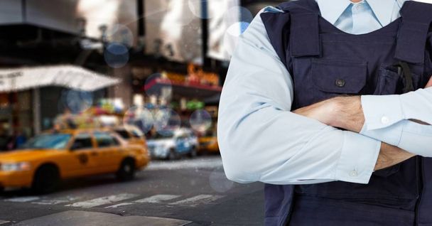 Policeman crossing his arms in a street in front of a yellow taxi - Foto, imagen
