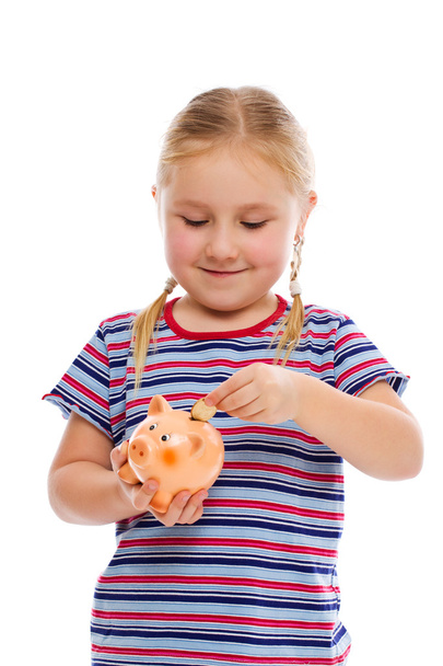 little girl with piggy bank - Fotó, kép