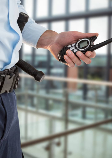 Security guard with walkie-talkie in the office with a blurred back - Φωτογραφία, εικόνα