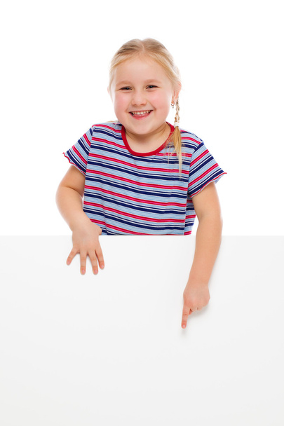 Little girl pointing at whiteboard. - Valokuva, kuva