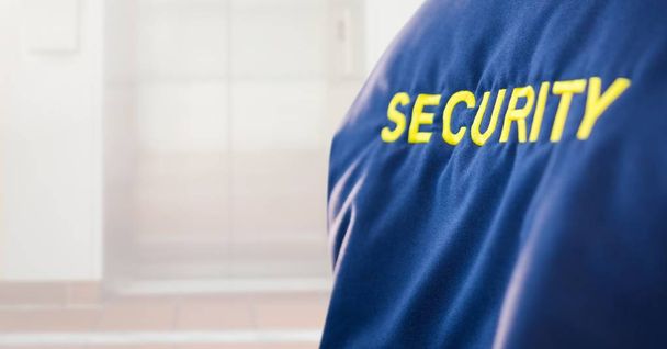 Security man outside bright background lift door - Foto, Imagem
