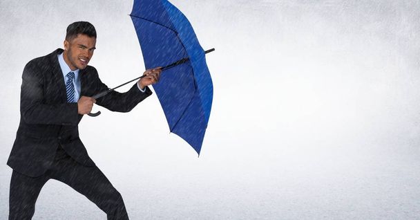 Business man with umbrella blocking rain against white background - Zdjęcie, obraz