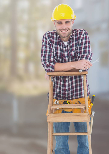 Construction Worker on ladder in front of construction site - Φωτογραφία, εικόνα