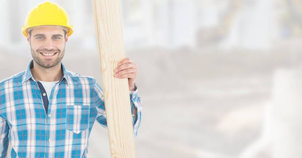 Carpenter with wood on building site - Foto, afbeelding