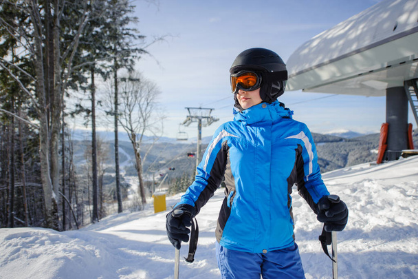 Portrait of female skier on the top of ski slope - Photo, Image