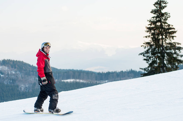 Male boarder on his snowboard at winer resort - Fotografie, Obrázek