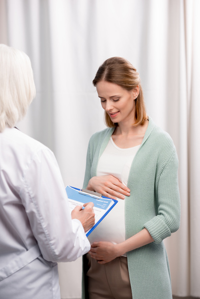 doctor with pregnant woman during consultation - Photo, Image
