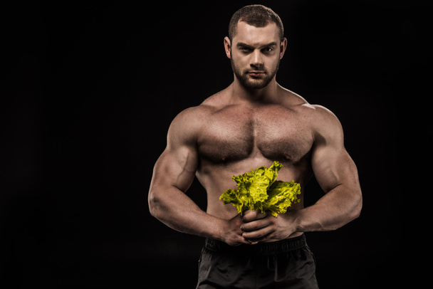 shirtless sportsman holding salad leaves - Foto, Imagem
