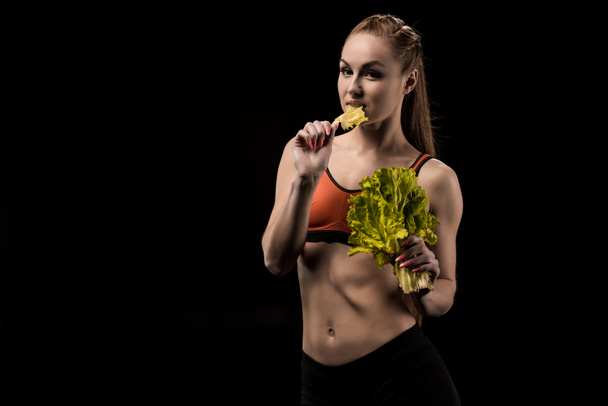 sportswoman eating Lettuce salad leaves - Photo, Image