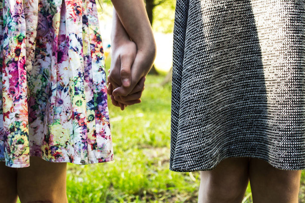sisters holding hands outdoor - Photo, Image