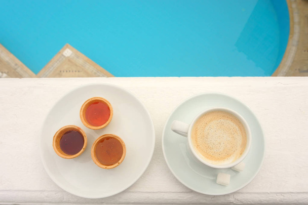 Cup of  coffee  on the background of the pool - Foto, imagen