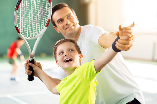 Happy child playing sport game with his parent - Zdjęcie, obraz