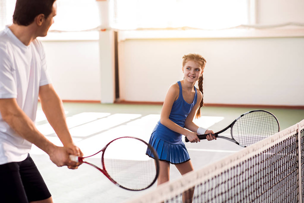 Excited child and dad having fun on tennis court - Photo, Image
