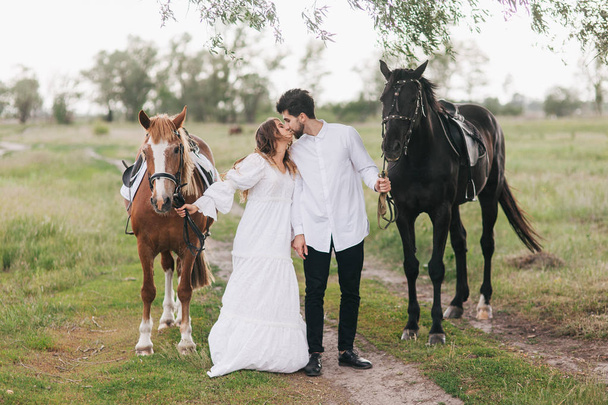 couple walk with horses - Foto, Imagen
