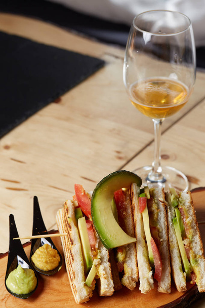 Vegan Club Sandwich with avocado on wooden tray - Fotografie, Obrázek