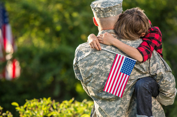 Happy reunion of soldier with family outdoors - Photo, image