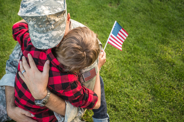 Happy reunion of soldier with family outdoors - Foto, Imagen