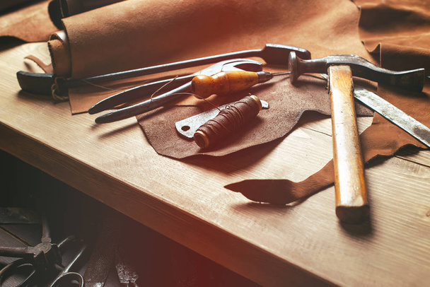 Cobbler tools in workshop on the wooden table . Top view. - Photo, Image