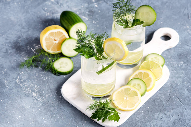 Detox water with cucumber lemon and lime Cold drink Cold lemonad with vegetables and citrus fruits - Foto, Bild