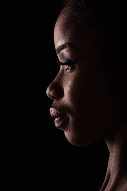 Dark skinned model on a side view portrait. - Foto, Imagen