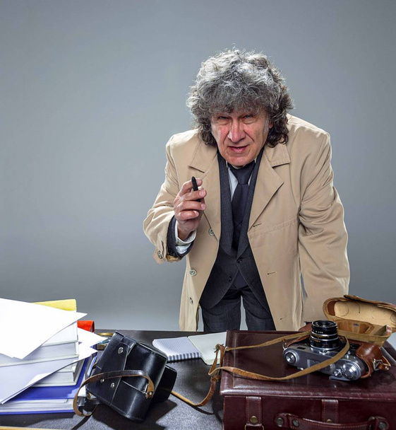 The senior man as detective or boss of mafia on gray studio background - Foto, Imagen