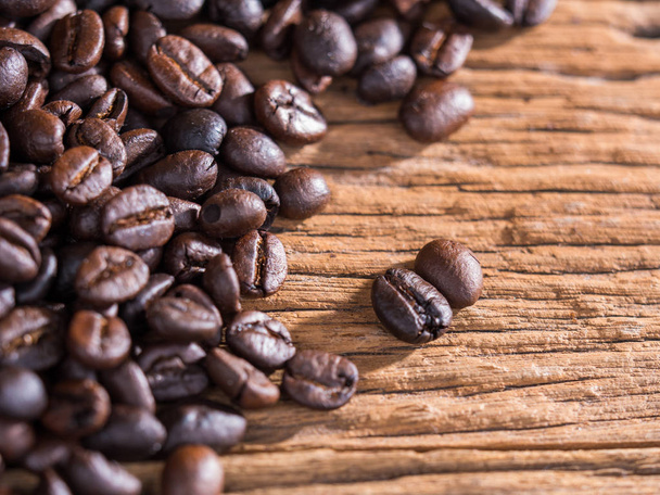black roasted coffee beans on aged wood - Foto, imagen