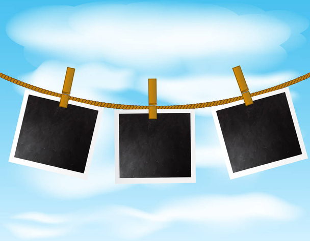 Набор пустых рамок для фотографий, висящих на веревке с деревянными булавками на фоне неба
 - Вектор,изображение