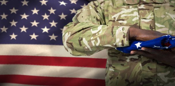 soldier holding american flag - 写真・画像