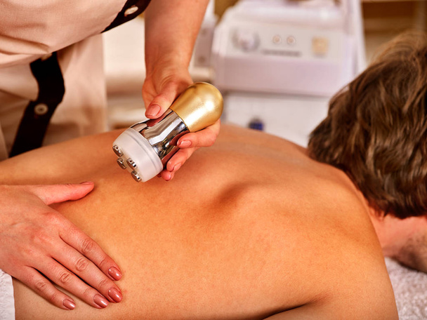 Man back massage beauty salon. Electric stimulation man skin care . - Photo, Image