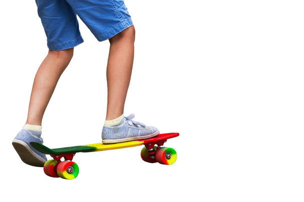 Adorable toddler boy having fun with colorful skateboard outdoor - Foto, imagen