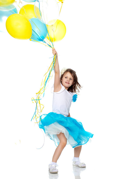 Little girl with multicolored balloons. - Фото, зображення